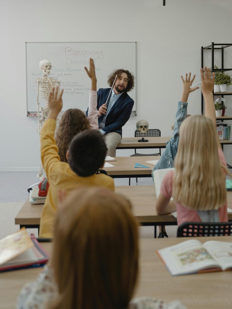 A classroom with a teacher and students actively participating in a lesson about biology.